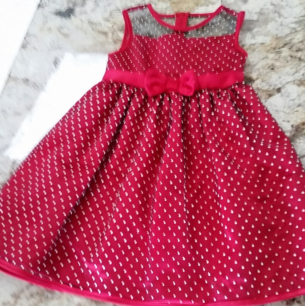 A dress that is red with white polka dots.
